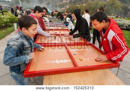 TBILISI, GEORGIA - OCT 16, 2016: Happy kids playing board game on the playground of Tbilisoba festival on October 16, 2016. Tbilisoba is traditional festival in capital of Georgia from 1979