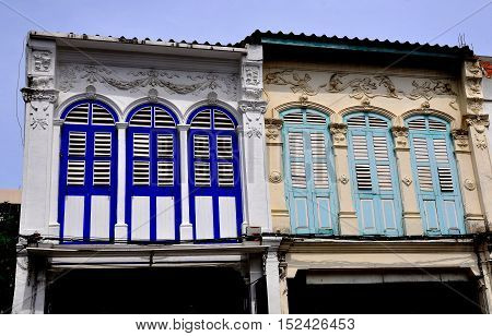 Phuket City Thailand - January 8 2012: Rarly 20th century Sino-Portuguese shop houses with louvered wooden shutters and decorative pargetting in the Krabi Road historic district