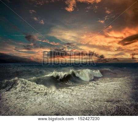View of great storm on the sea. Strong wind and big waves with splash drops under dark sky.