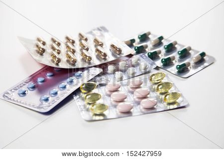 Medicine pills or capsules with syringe on white background. Drug prescription for treatment medication. Pharmaceutical medicament. Injection with vaccine