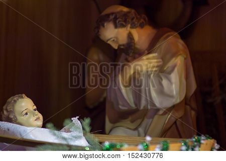 figurines of Joseph in the manger Jesus was born