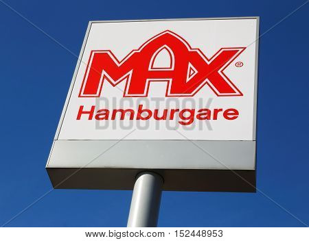 Ornskoldsvik, Sweden - March 28, 2014: The Swedish hamburger chain Max restaurants logo on pole against blue sky.