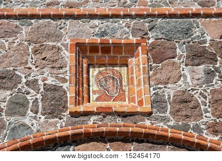 KUREMAE, IDA-VIRUMAA COUNTY, ESTONIA - AUGUST 21, 2016: Mosaic icon of Mother of God on the facade of The Saint Gate with Belfry in Puhtitsa Orthodox Dormition Convent.
