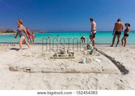 Elafonisi, Island Crete, Greece, - June 26, 2016: Swimming and relaxing people  on the beautiful beach of Elafonisi with pink sand
