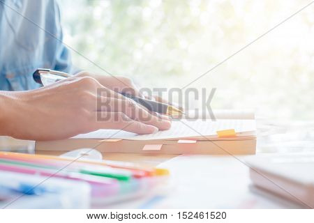 Vintage tone of collegian woman reading book in library. Education idea concept. Reading and researching for exam. The student life.