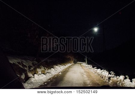 way through the snow at night in the moonlight covered in mist