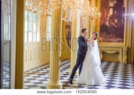 Full length of wedding couple dancing in church