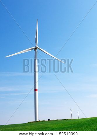a single windmill infron of the blue sky