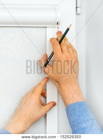 Man Installing Cassette Roller Blinds On Windows.