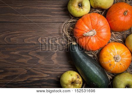 Autumn Pumpkin Thanksgiving Background - orange pumpkins over wooden table, top view