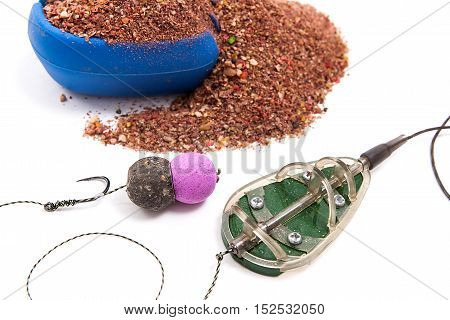 Dry Feed For Carp Fishing. Ready For Use Carp Bait With Fishing Flat Feeder For Carp Fishing Isolate