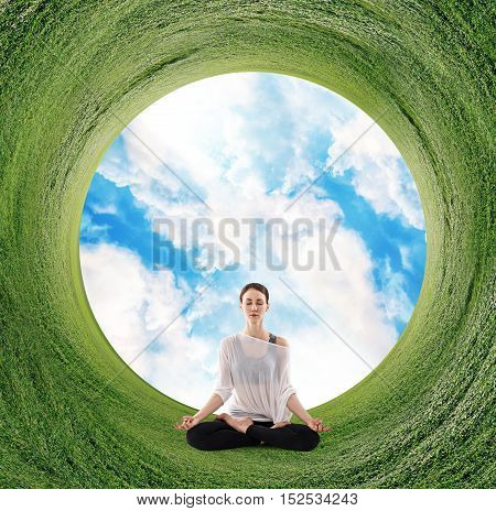 Stereographic panoramic projection of a green field with woman sitting in yoga position