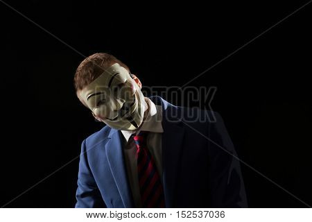 London - UK - 19 October 2016 - Businessman wearing a hacker mask. This mask is a well-known symbol for the online hacktivist group Anonymous