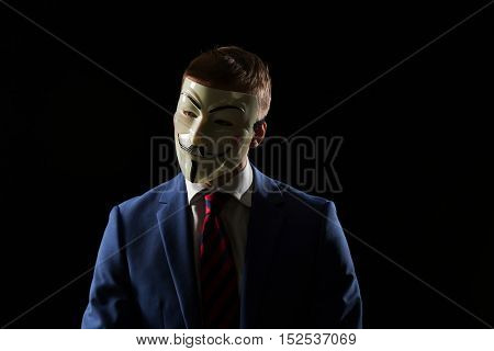 London - UK - 19 October 2016 - Businessman wearing a hacker mask. This mask is a well-known symbol for the online hacktivist group Anonymous