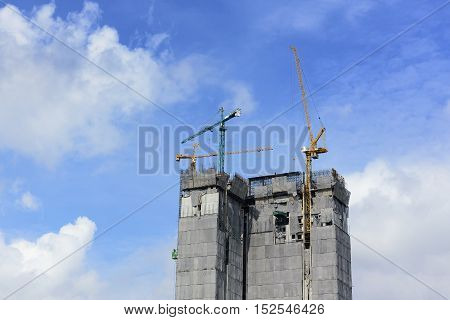 under construction building with the crane and the sky.