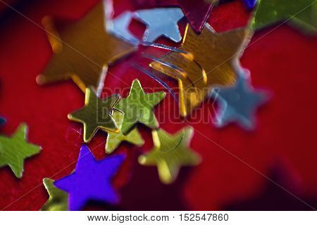 small multi-colored stars on a red background