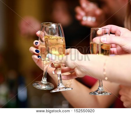 Holiday Event people cheering each other with champagne and wine