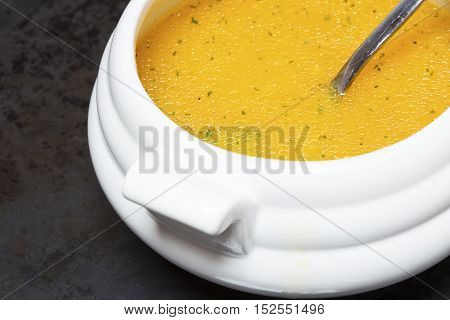 Pumpkin soup in a white porcelain bowl