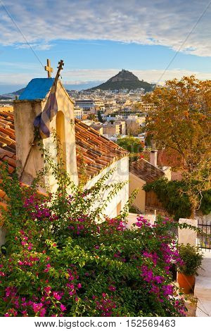 Lycabettus hill and a small Greek orthodox church in Anafiotika, Athens.