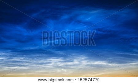 Blue clouds in the night sky. In summer.