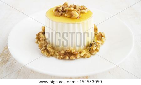 Burgos cheese with honey and walnuts on white plate. Traditional Spanish dessert selective focus horizontal