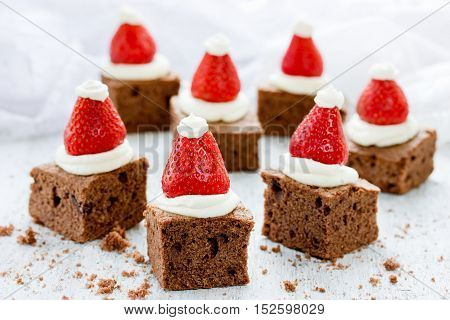 Santa Hat Brownie Bites with strawberries and whipped cream or frosting - great Christmas cookie swap idea