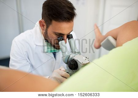 Young Professional Gynecologist Exam Patient With Colposcope