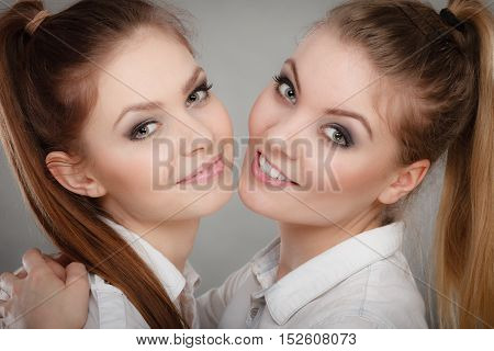 Family and relations. Love and affection concept. Two lovely attractive women playing together. Charming playful sisters have fun smiling.