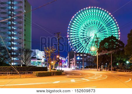 Tempozan ferris wheel at night with cityscape