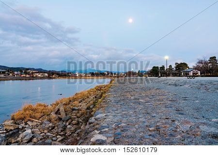 Arashiyama stream in Kyoto at night with moon