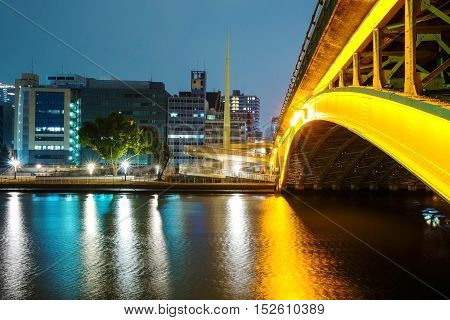 Bridge and buildings along Yodo river at night