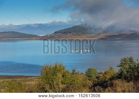 Amazing Autumn Landscape with Low clouds over water of Batak Reservoir, Pazardzhik Region, Bulgaria