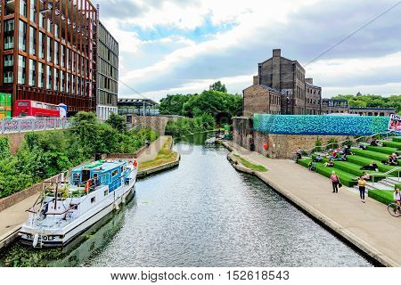 LONDON - AUGUST 22: The Regents Canal in Kings cross where many University students often sit around on the stairs enjoying the view on August 22nd 2016 in London