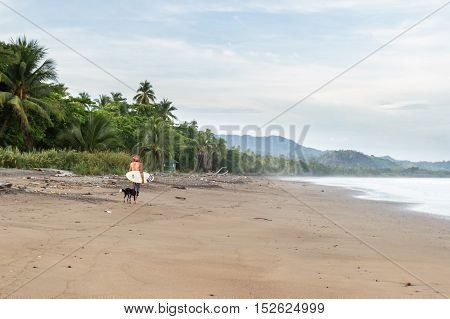 Surfer Walking On The Beach