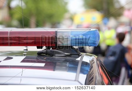red and blue flashing lights of police patrol during an uprising in the city