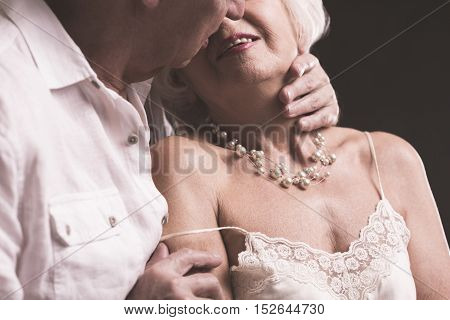 Senior Couple Kissing And Embracing