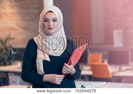 Arabian Business Woman Holding A Folder In Modern Startup Office