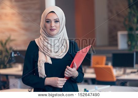 Arabian Business Woman Holding A Folder In Modern Startup Office