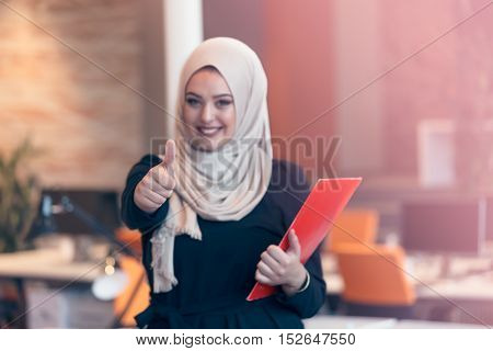 Arabian Business Woman Holding A Folder In Modern Startup Office