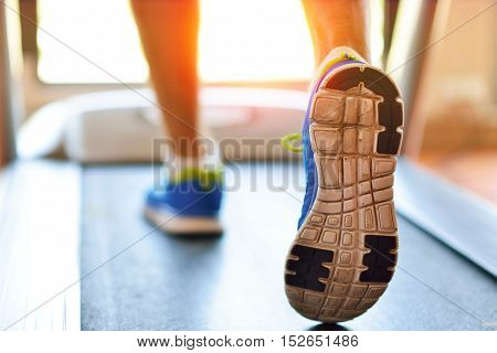 Man Running In A Gym On A Treadmill Concept For Exercising, Fitness And Healthy Lifestyle