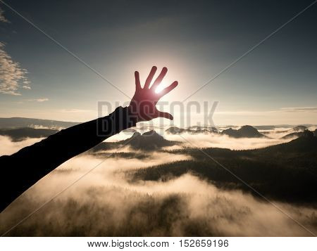 Man Hand Touch Sun. Misty Daybreak In A Beautiful Hills. Hilly Landscape In Fog