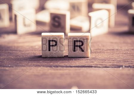 Business conceptual word PR collected of of wooden elements with the letters