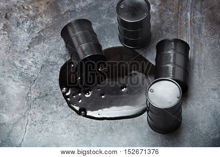 High angle view on four fuel drums with spilled oil