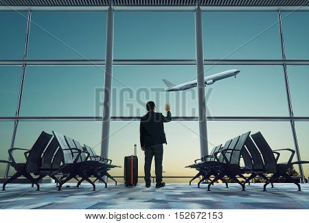 young businessman waving good bye at airport