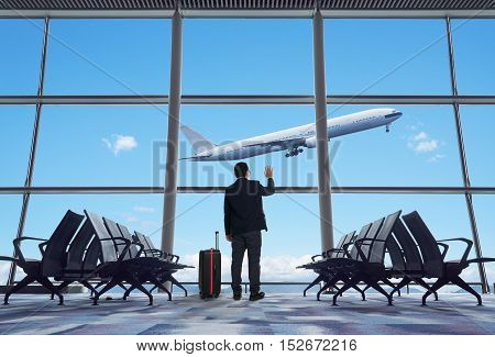 young businessman waving good bye at airport