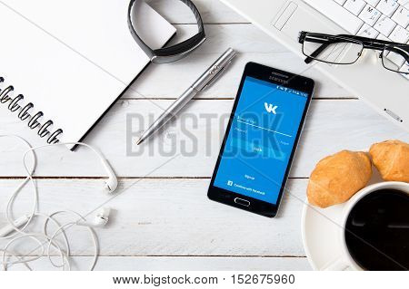 WROCLAW POLAND- OCTOBER 18th 2016 : Samsung A5 with VK application laying on desk. VK is the largest European online social networking service and is especially popular among Russian-speaking users.