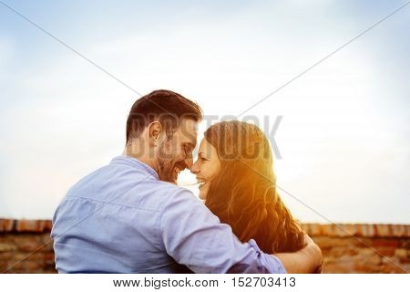 Romantic cute young couple eskimo kissing outdoors