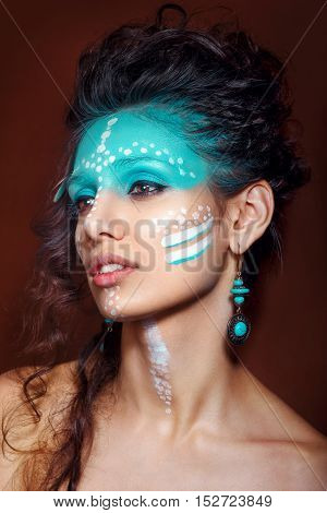 attractive young woman in ethnic jewelry with drum. close up portrait. Beautiful girl shaman. Portrait o