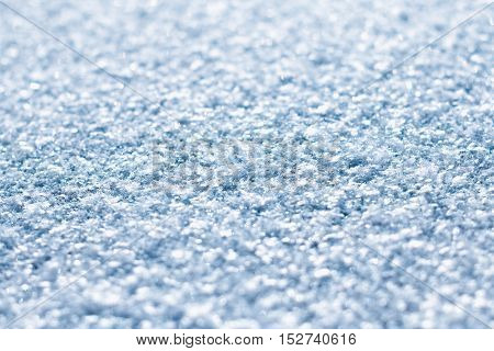 Glittering blue snow texture macro, shallow depth of field