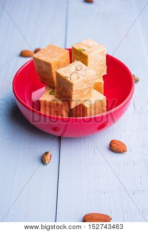 Close-up of soan papdi or son papdi with almonds and pistachio or pista